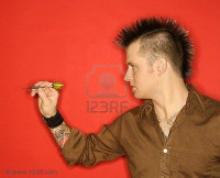 2457867-side-view-of-caucasian-man-with-mohawk-holding-dart-against-red-background.jpg