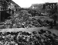 Rows_of_bodies_of_dead_inmates_fill_the_yard_of_Lager_Nordhausen,_a_Gestapo_concentration_camp.jpg