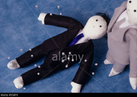 voodoo-doll-lying-down-dressed-as-a-business-man-w.jpg