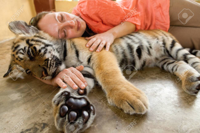 66780816-young-woman-hugging-baby-tiger-in-chiang.jpg